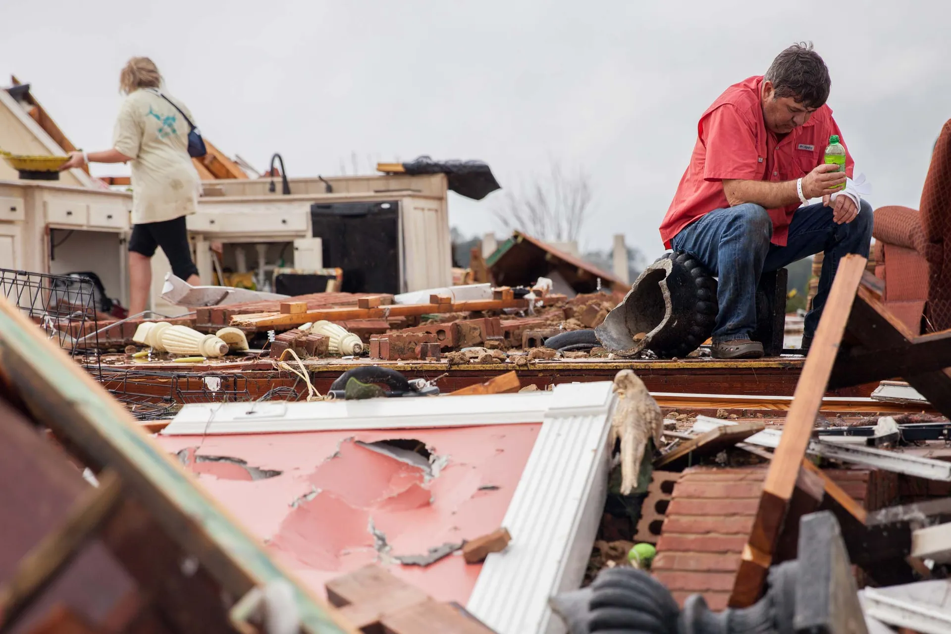Family surveys the damage to their home after a tornado in Adel, Georgia
